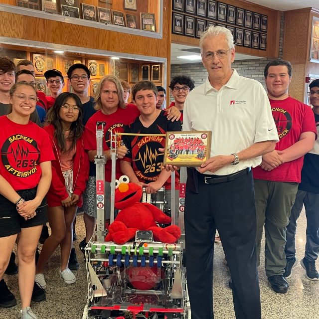Retlif VP Bill Hayes receives plaque from students